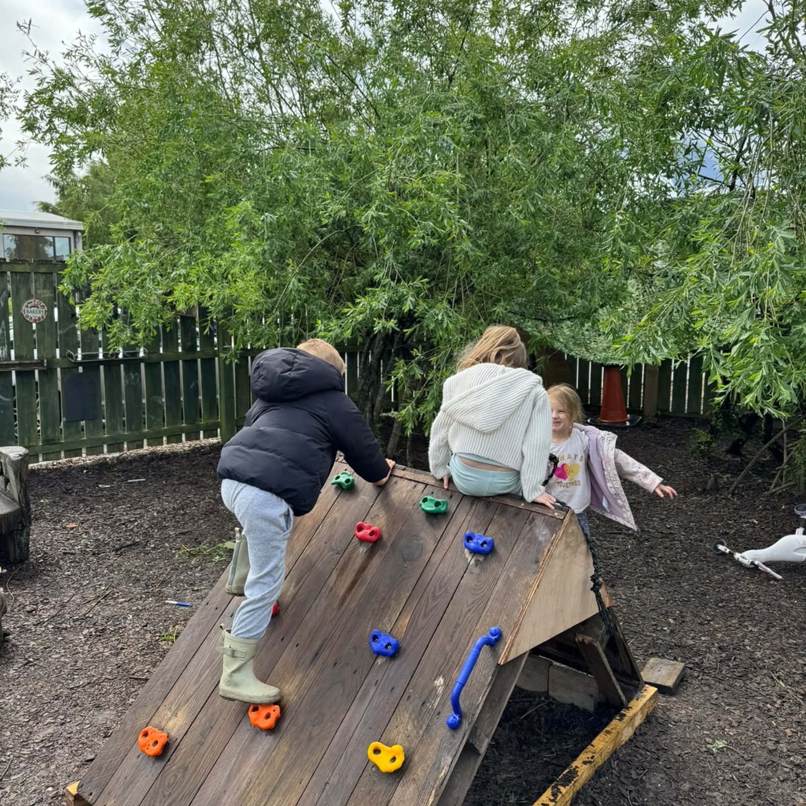 A practitioner and children exploring a sensory tuff tray