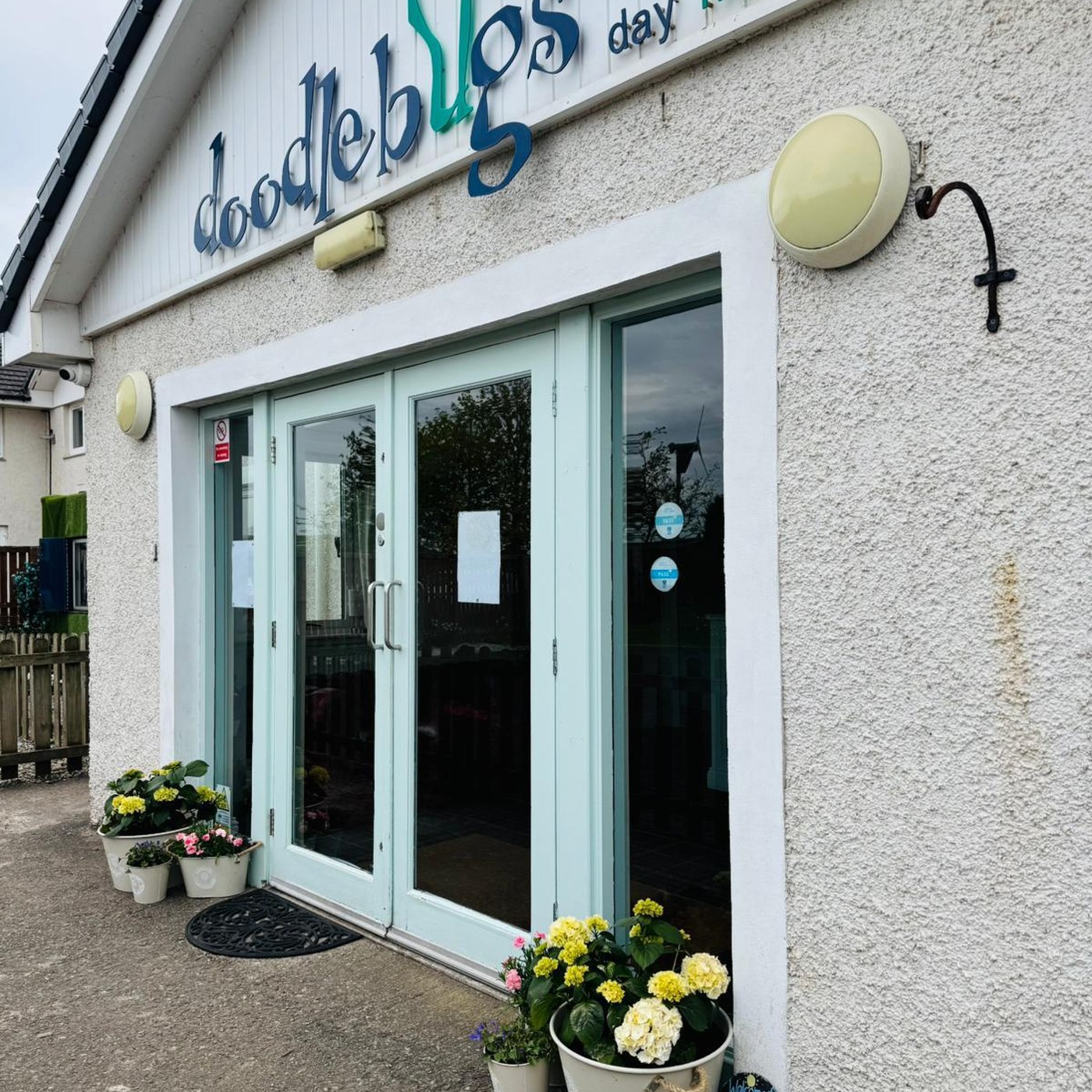 The Doodlebugs Aberuthven nursery front entrance with the doodlebugs sign and flowers