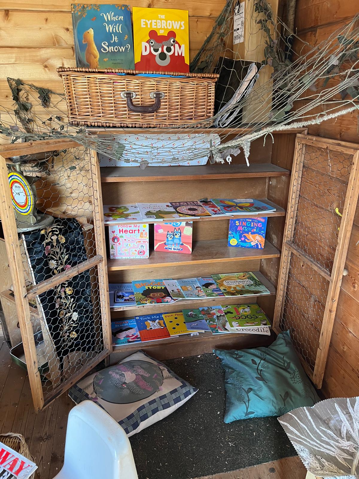 Books and cosy cushions in the Bridge of Earn garden cabin