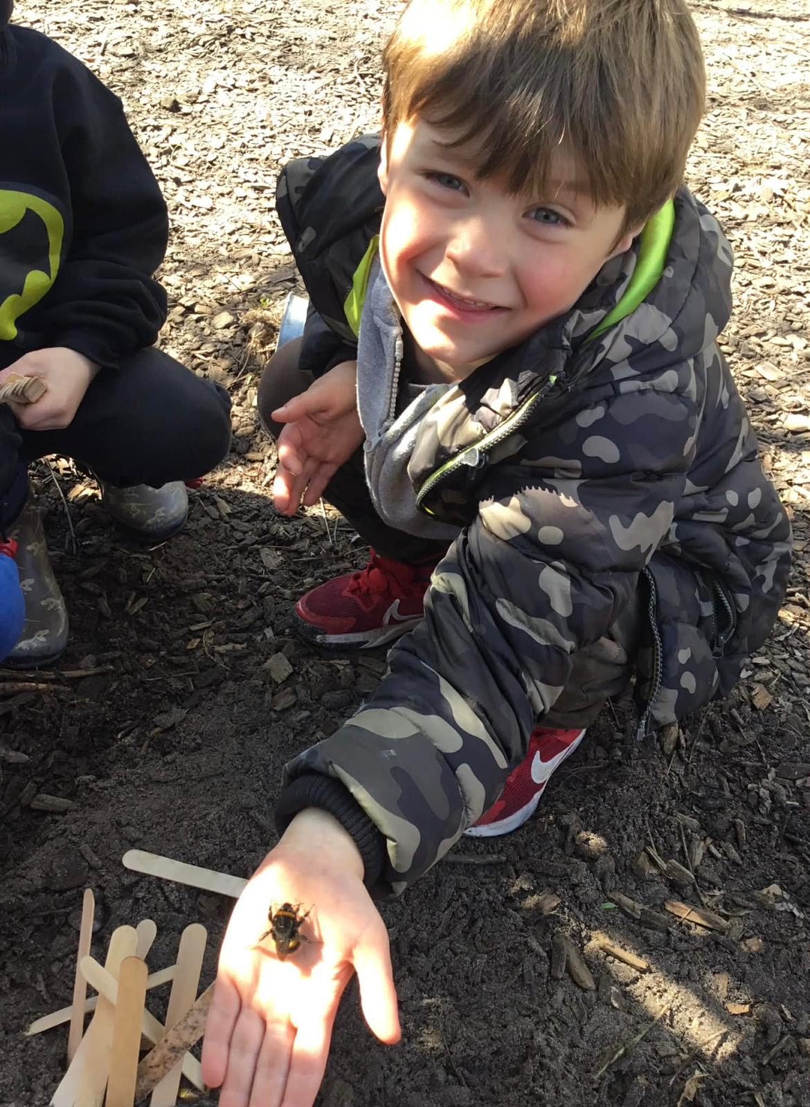 A child discovering nature outdoors
